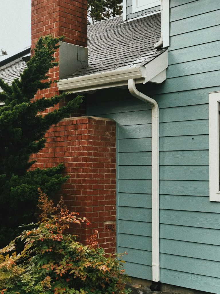 a-blue-house-with-a-red-brick-chimney-gvt-wjgk4s4